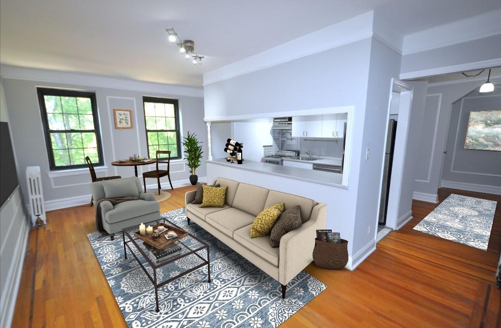 Large living room overlooks Garth Woods. The living room has a nook that is great for a home office set up while leaving plenty of room for a dining area.  The living room has hardwood floors, picture moldings and wall moldings.  The living room is 20 x 12.  Photo is virtually staged.