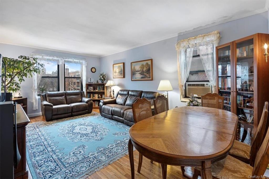 Living room featuring light hardwood / wood-style flooring and crown molding