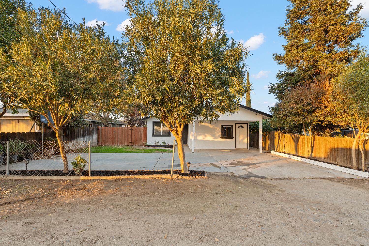 a view of a house with a tree and a yard