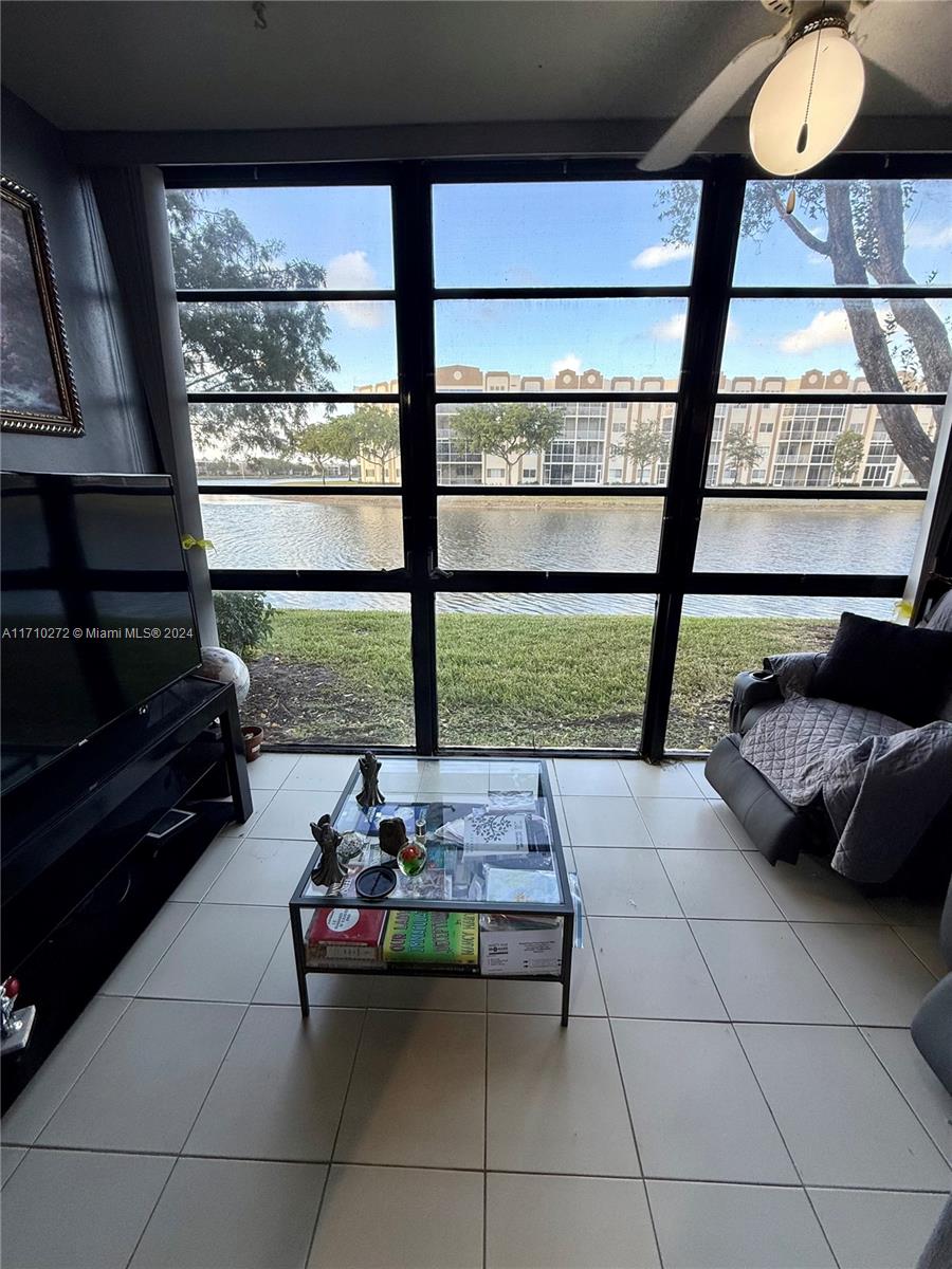 a living room with furniture and a floor to ceiling window