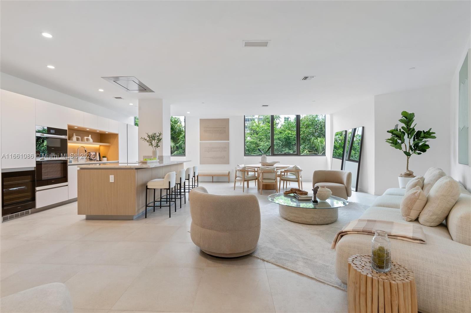 a living room with furniture and a kitchen area