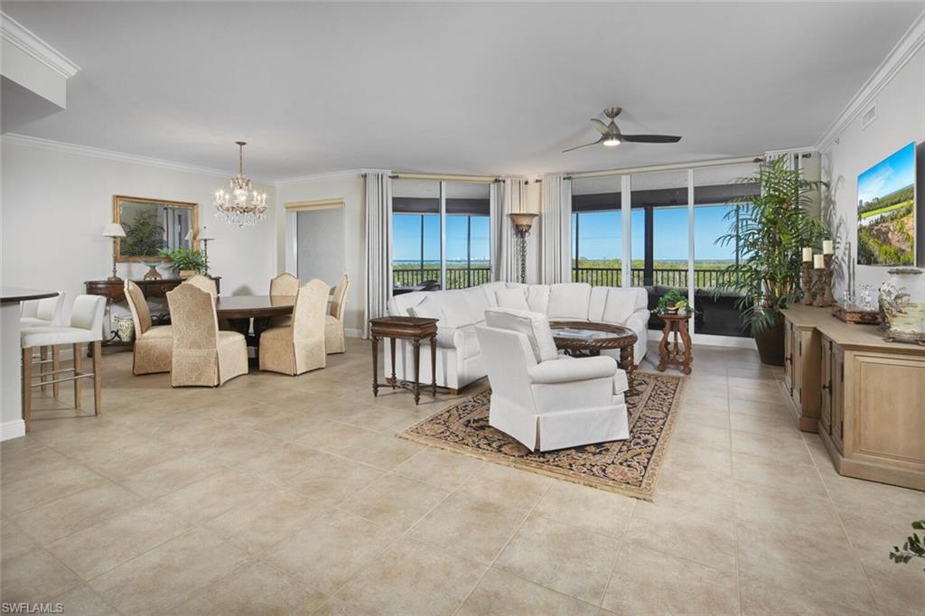 a living room with furniture and a chandelier