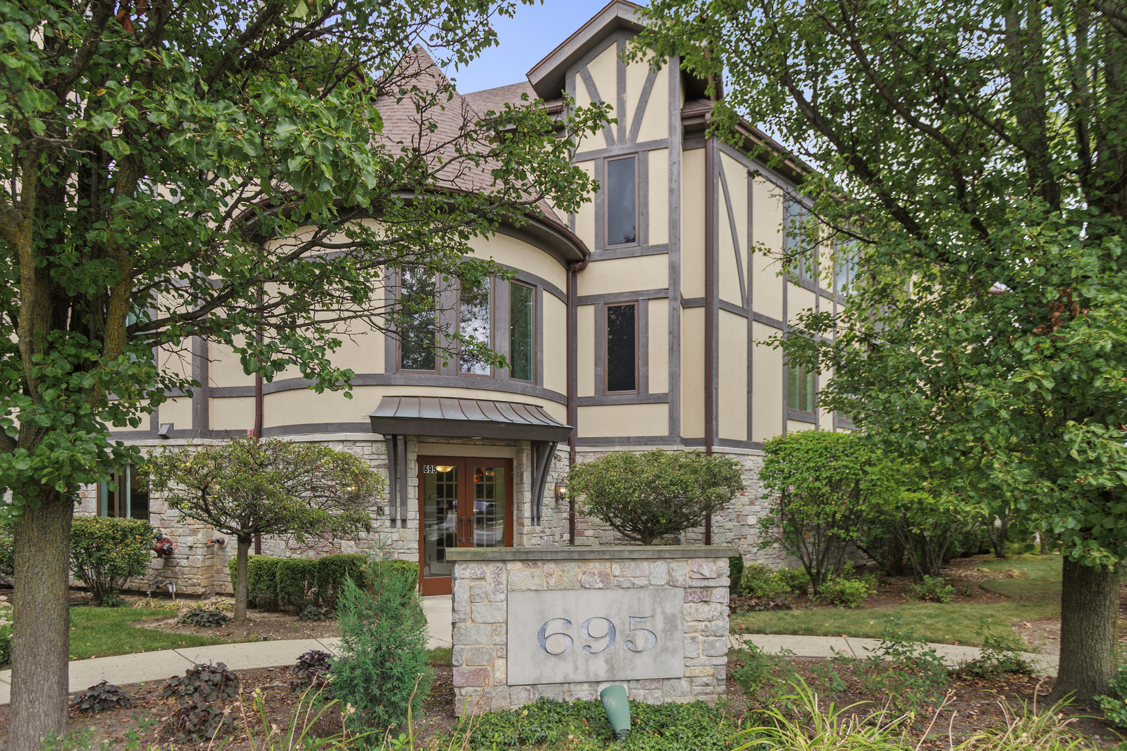 a front view of a house with garden