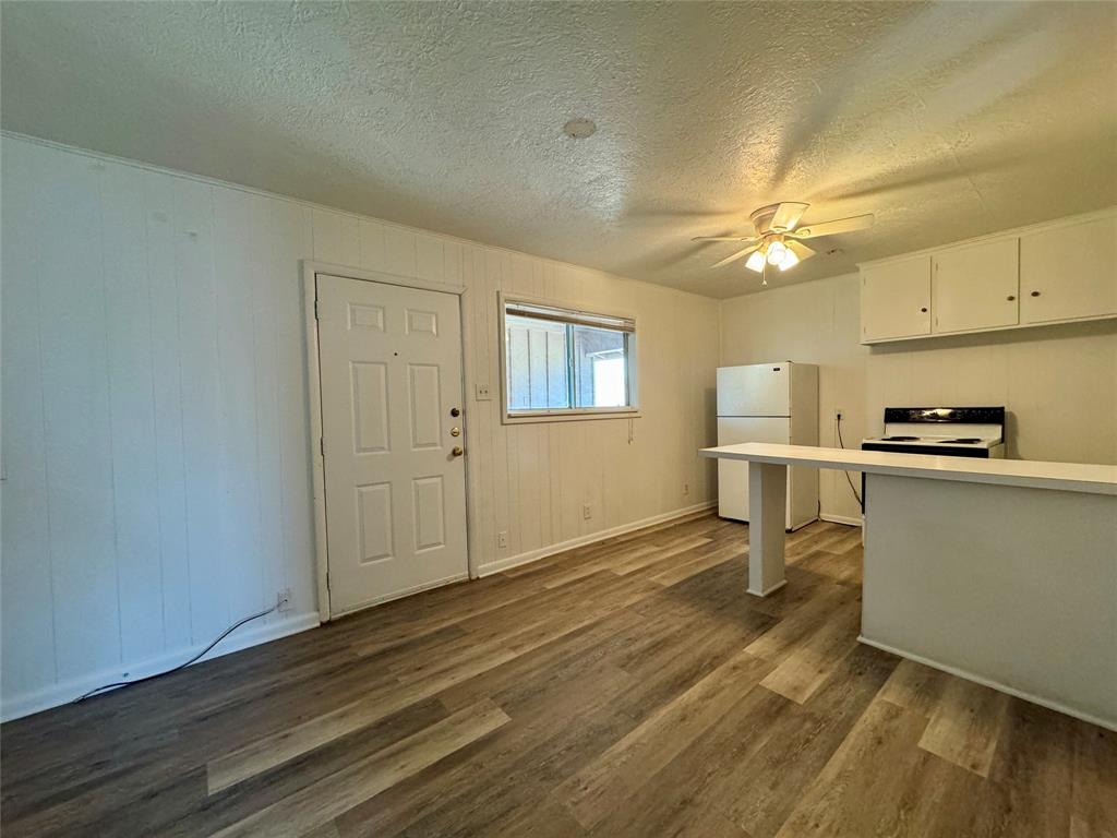 a view of kitchen with furniture and wooden floor