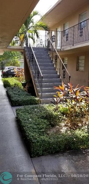 a view of balcony with lots of plants and trees