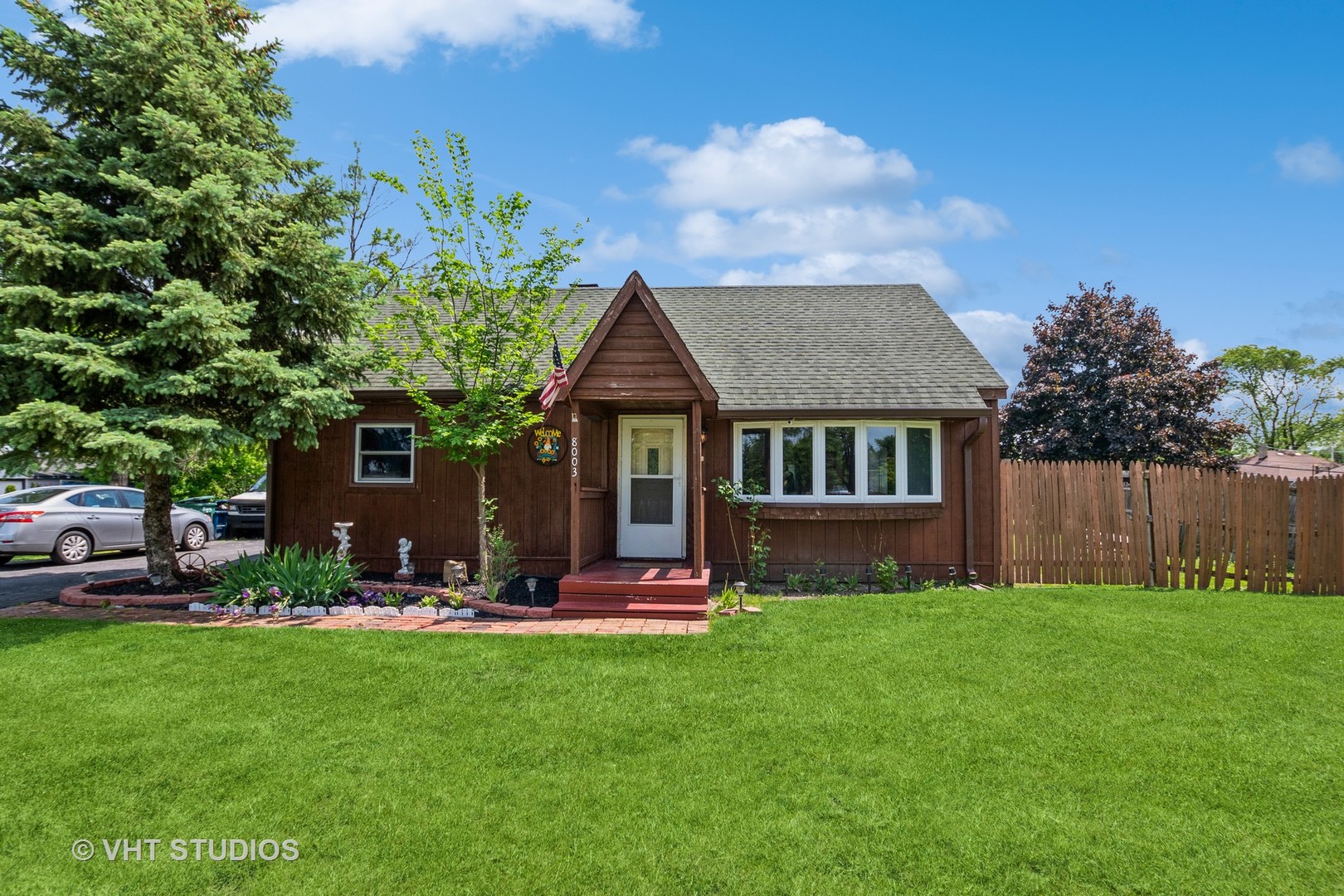 a front view of house with yard and green space