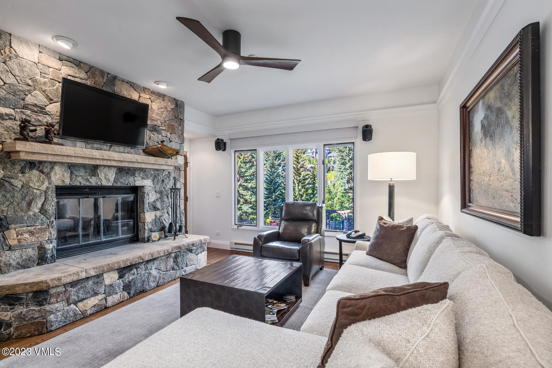 a living room with furniture a flat screen tv and a fireplace