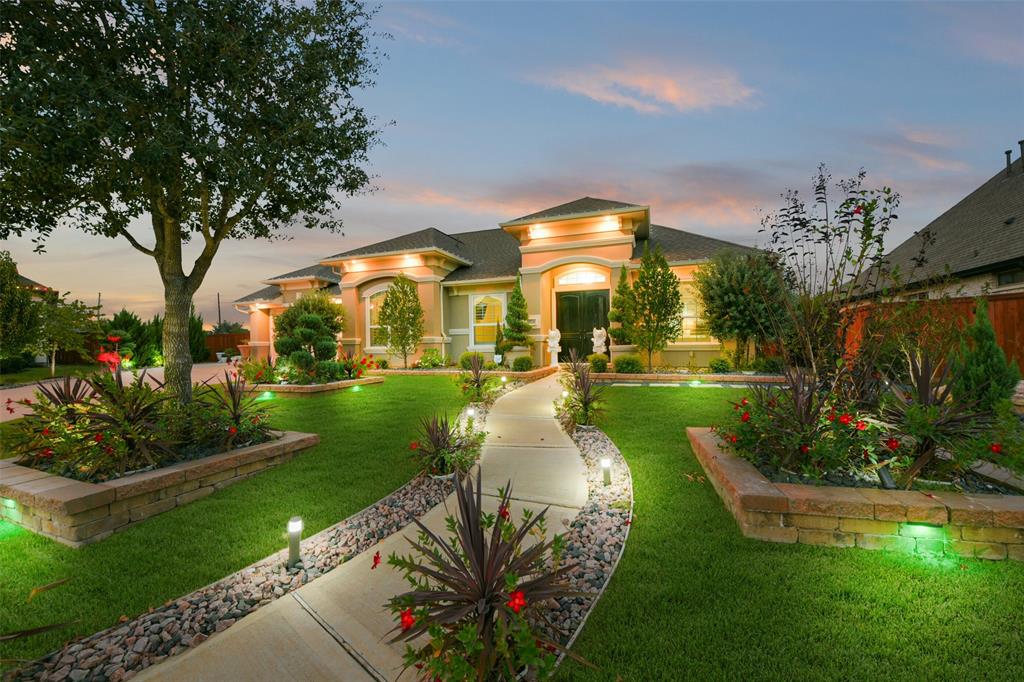 Gorgeous curb appeal with meticulously landscaped front yard—setting the perfect tone for this charming home at 19726 Hickory Heights Drive, Cypress, TX