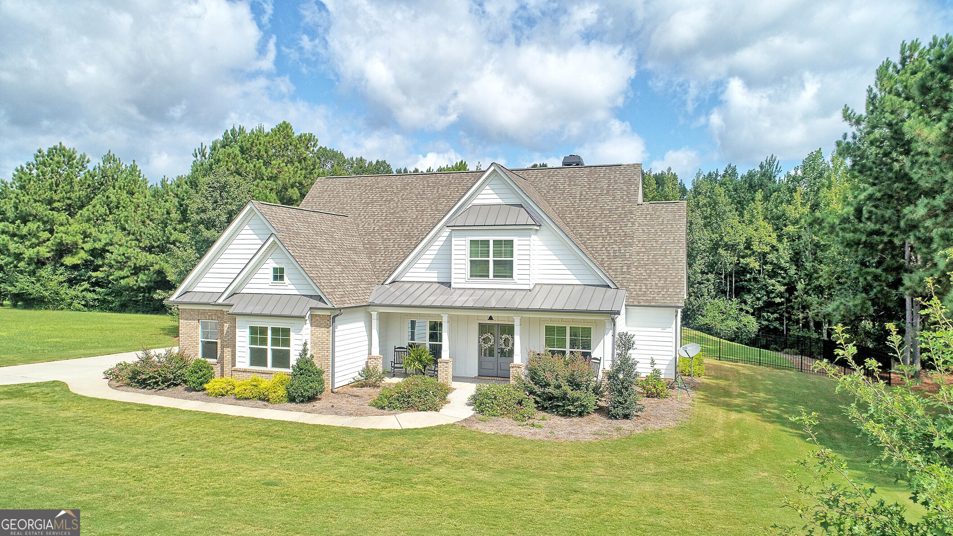 a front view of house with yard and green space