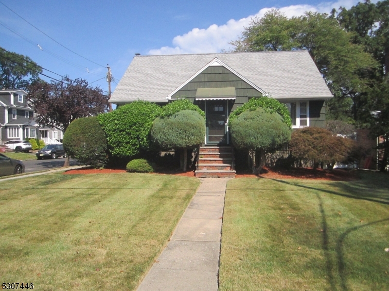 a front view of a house with yard and green space