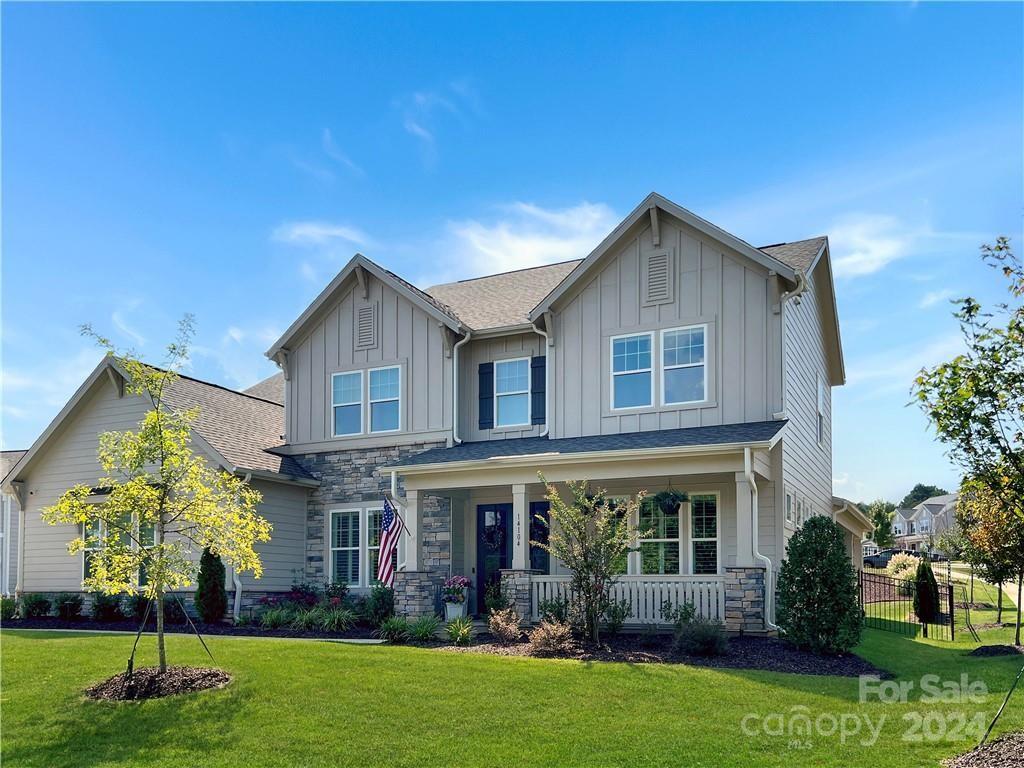 a front view of house with yard and green space