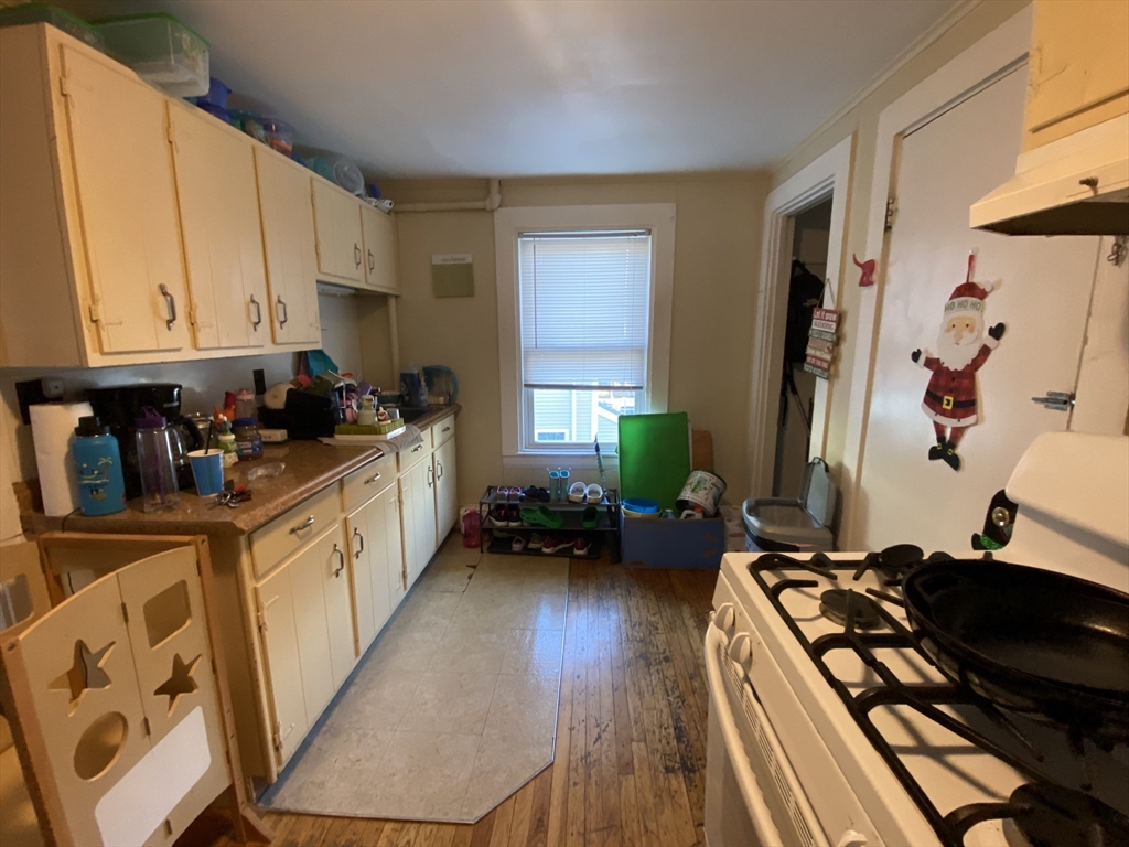 a kitchen with a sink stove top oven and cabinets