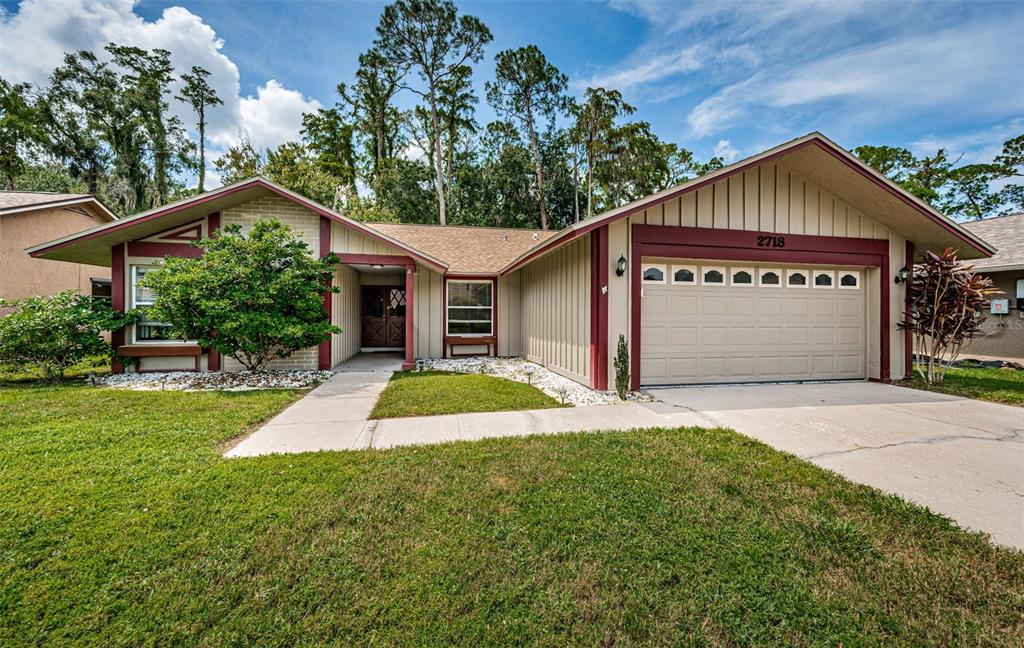 a front view of a house with a yard and garage