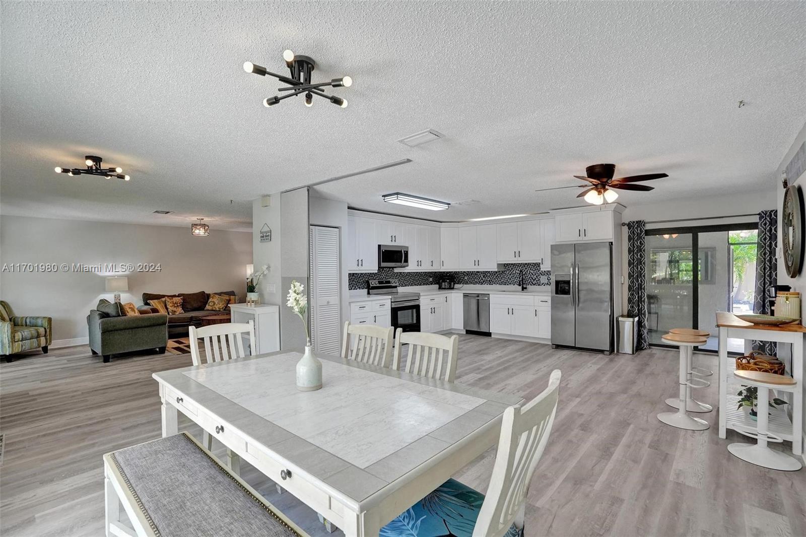 a living room with furniture and kitchen view