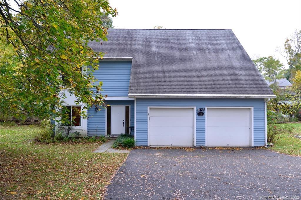 front view of a house with a yard and garage