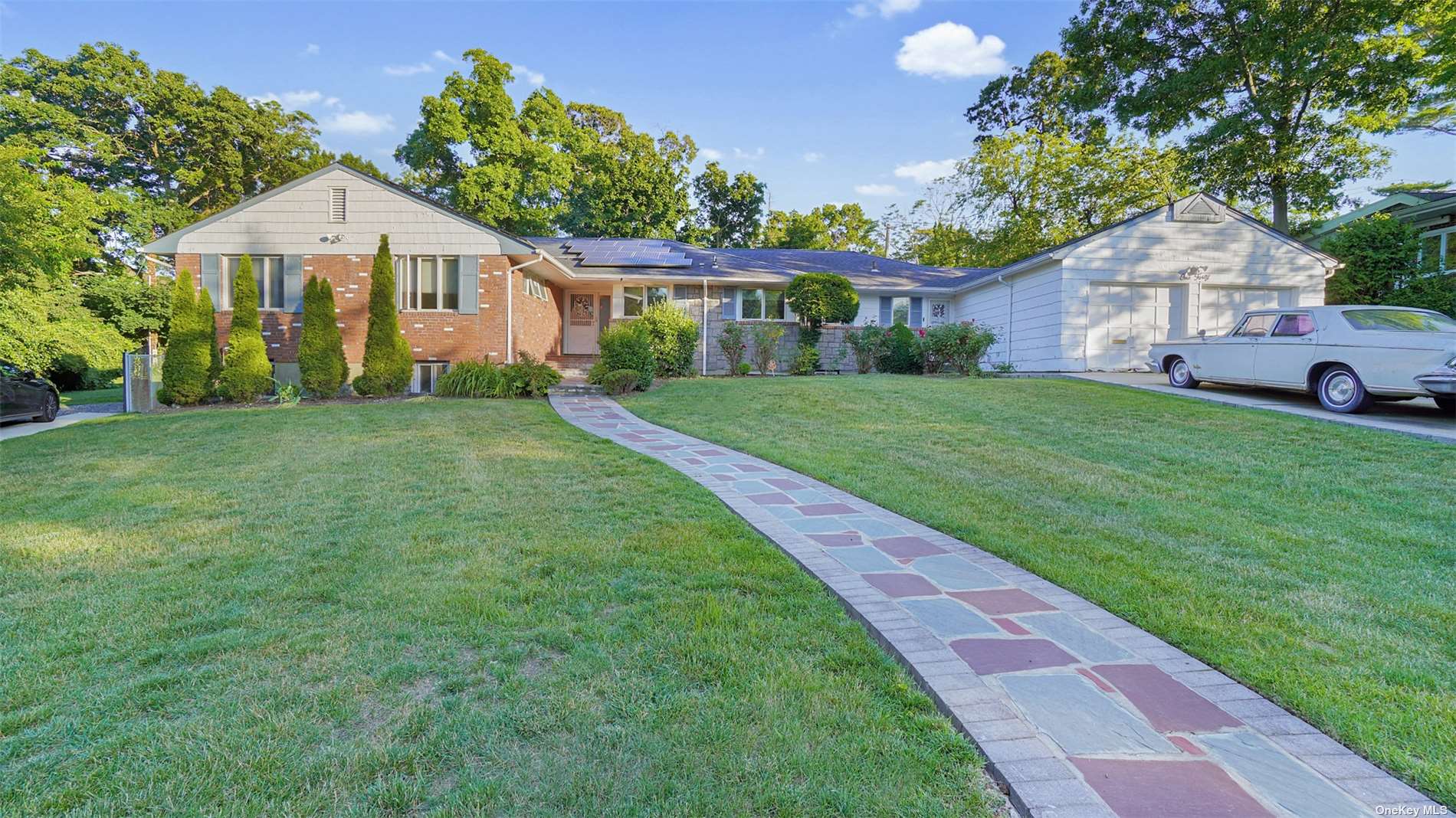 a front view of a house with a garden and porch