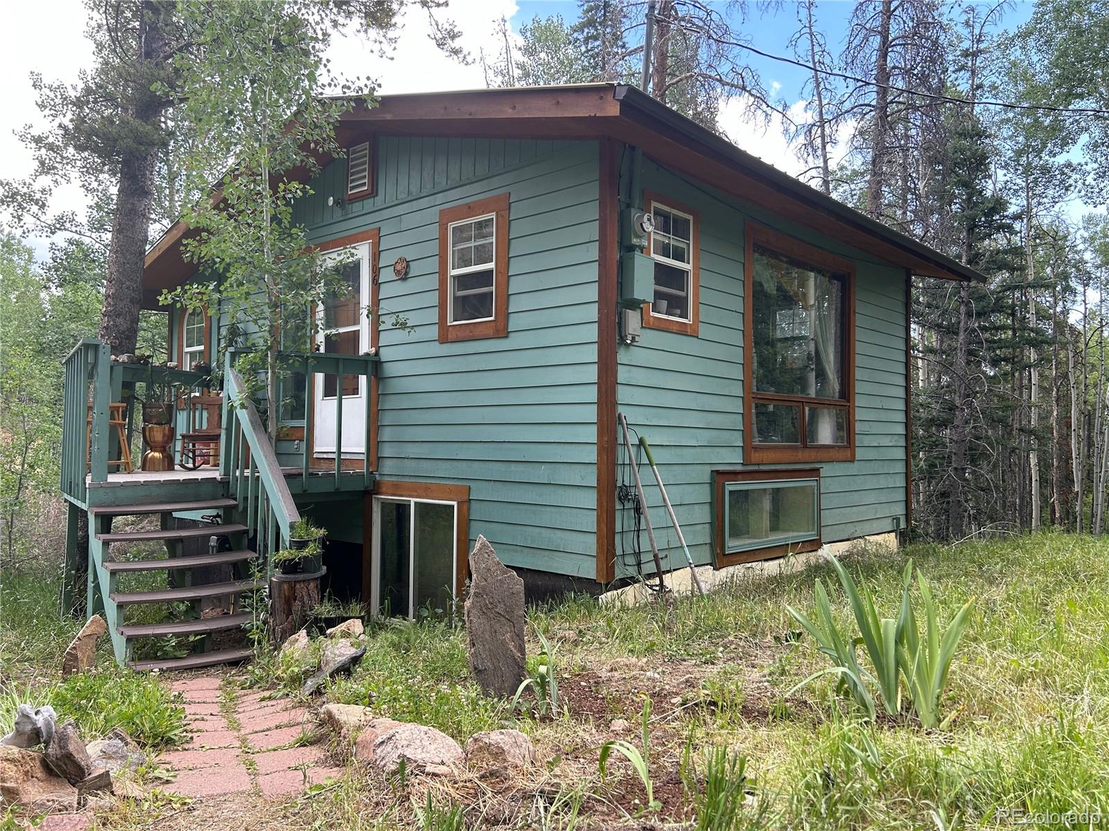 a view of a house with a yard and wooden fence