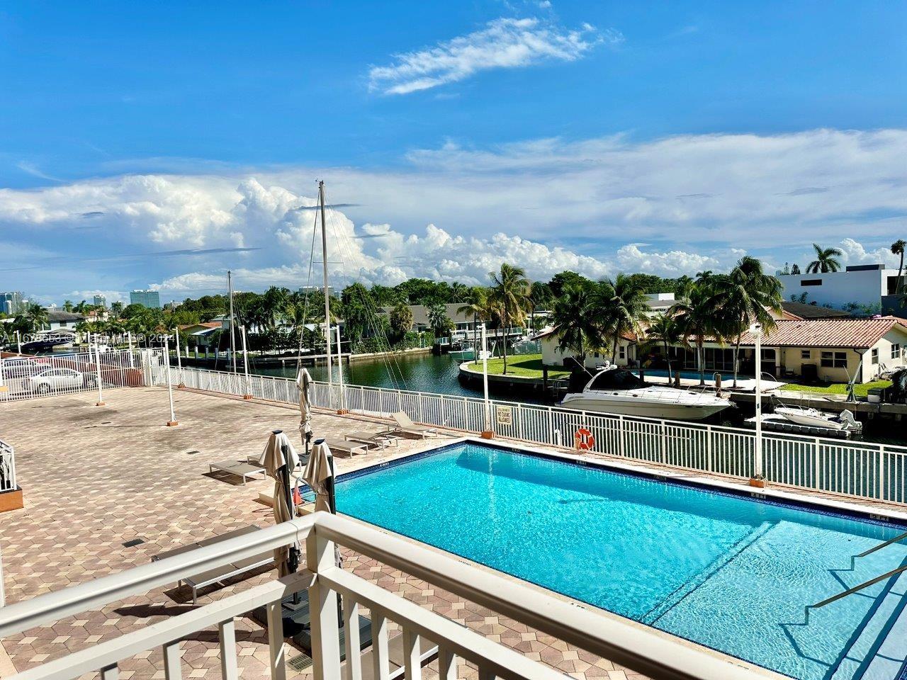 a view of a swimming pool with an outdoor seating