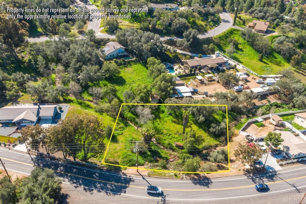 an aerial view of residential houses with outdoor space and street view