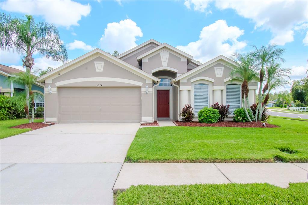 a front view of a house with a yard and garage