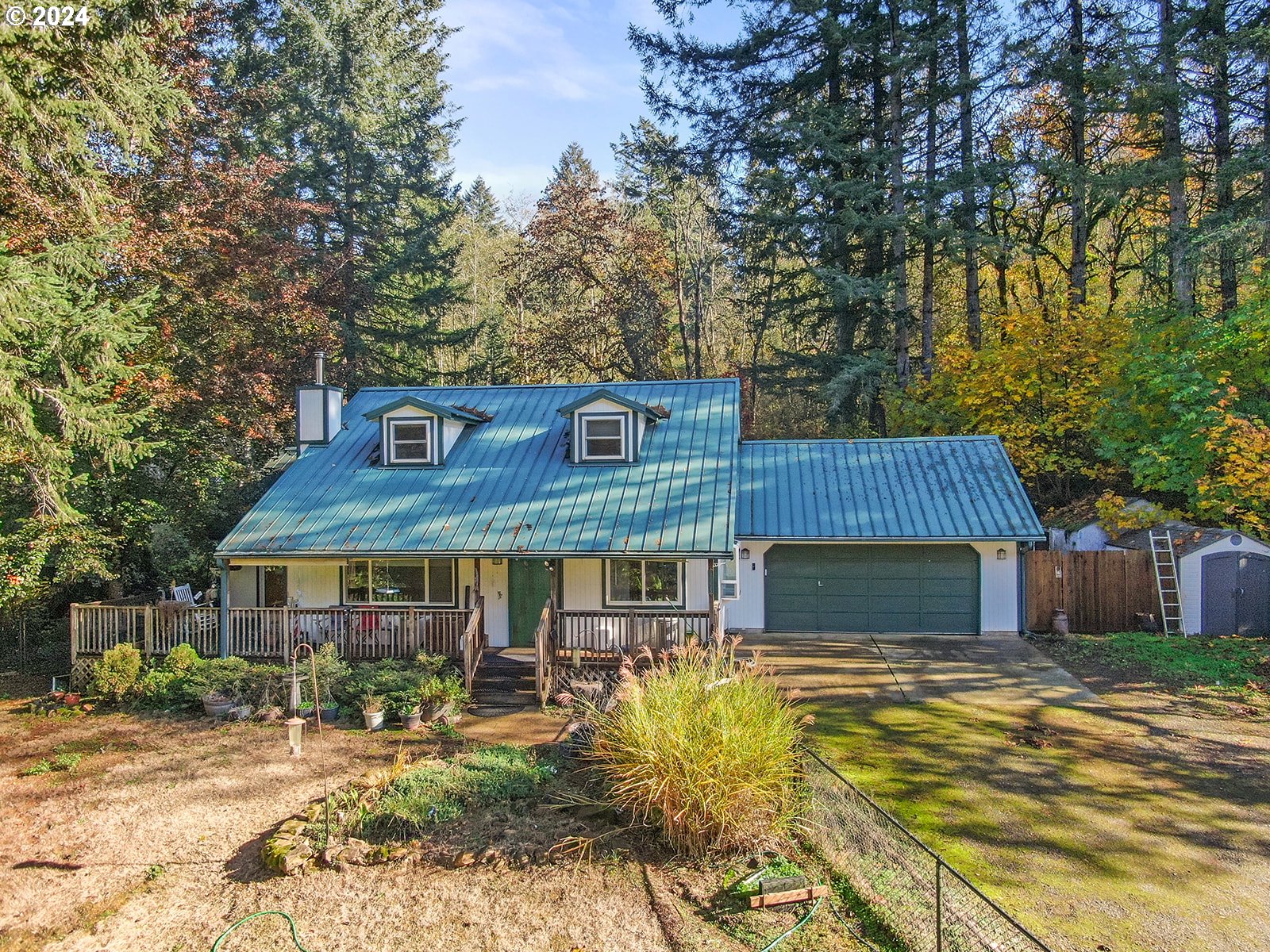 a view of a house with a yard and sitting area