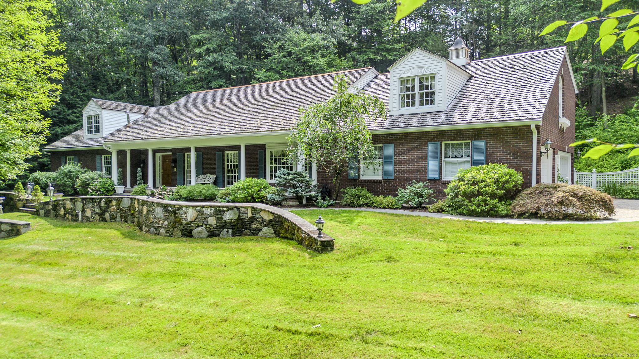 a view of a house with a yard patio and a swimming pool