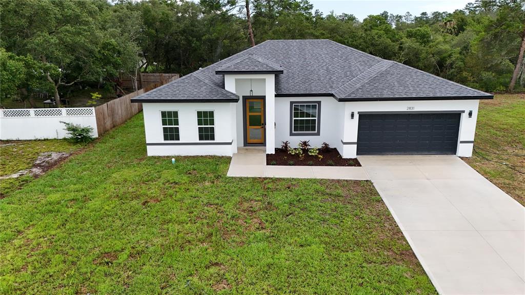 a front view of a house with a yard and garage