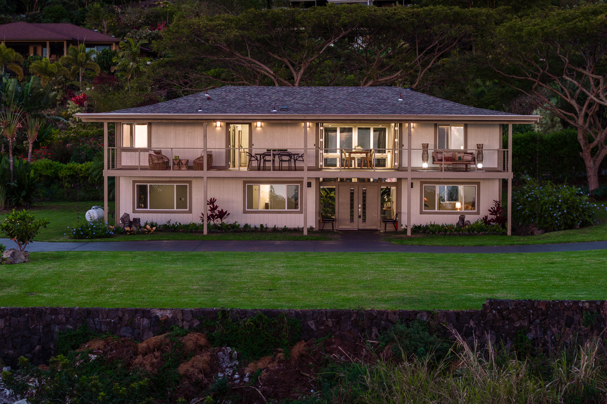 a front view of a house with a garden