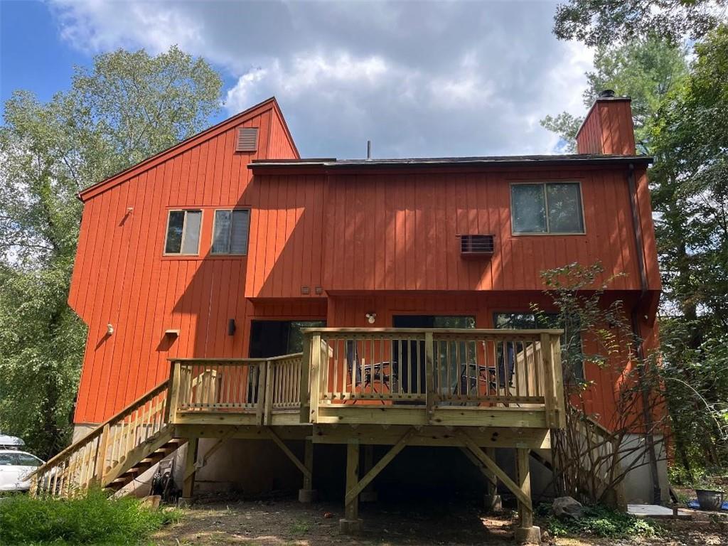 Back of property, featuring the new deck. Dual Staircases