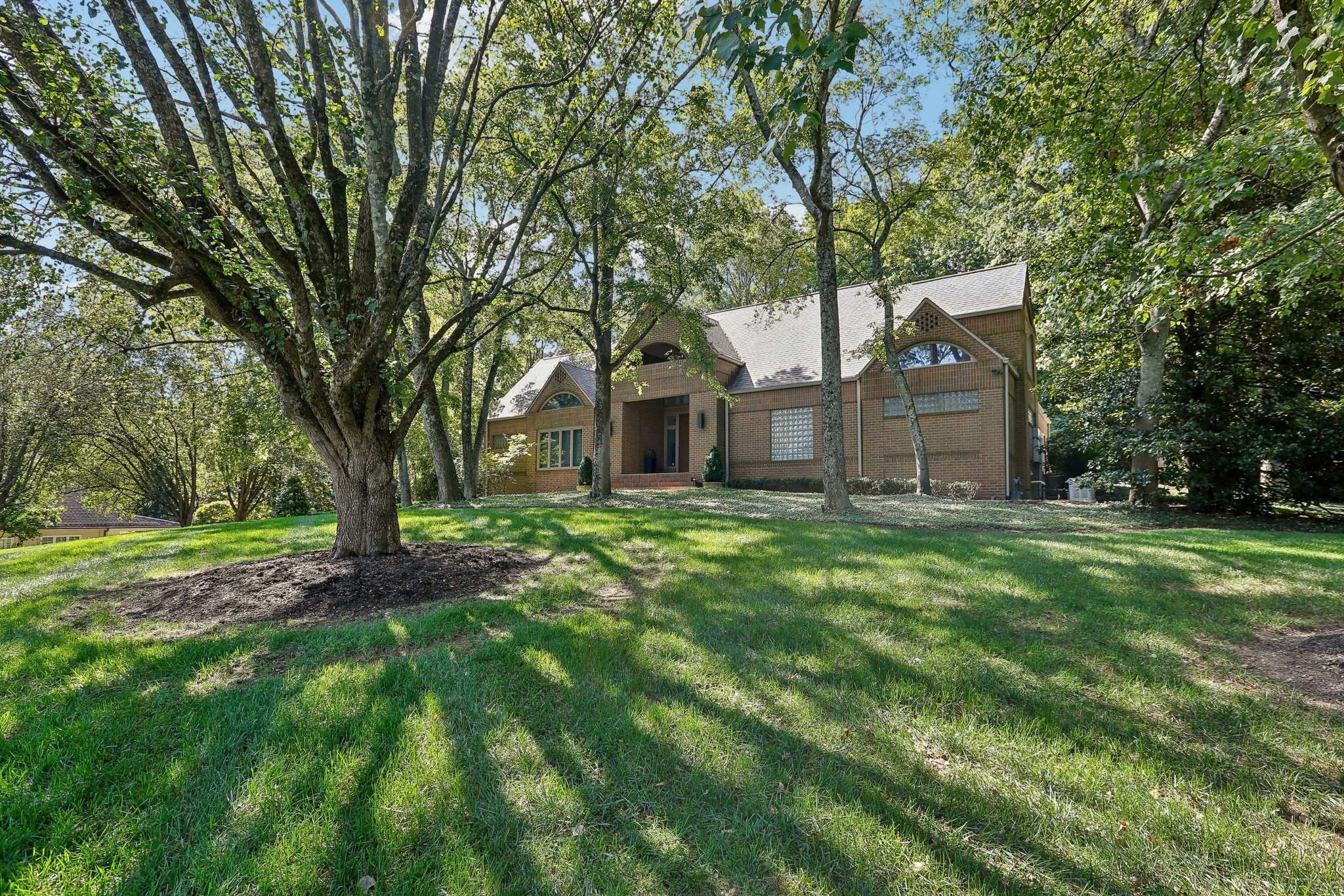 a front view of a house with a garden