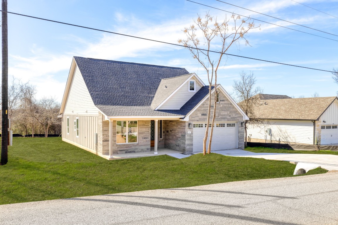 a view of a house with a yard and pathway