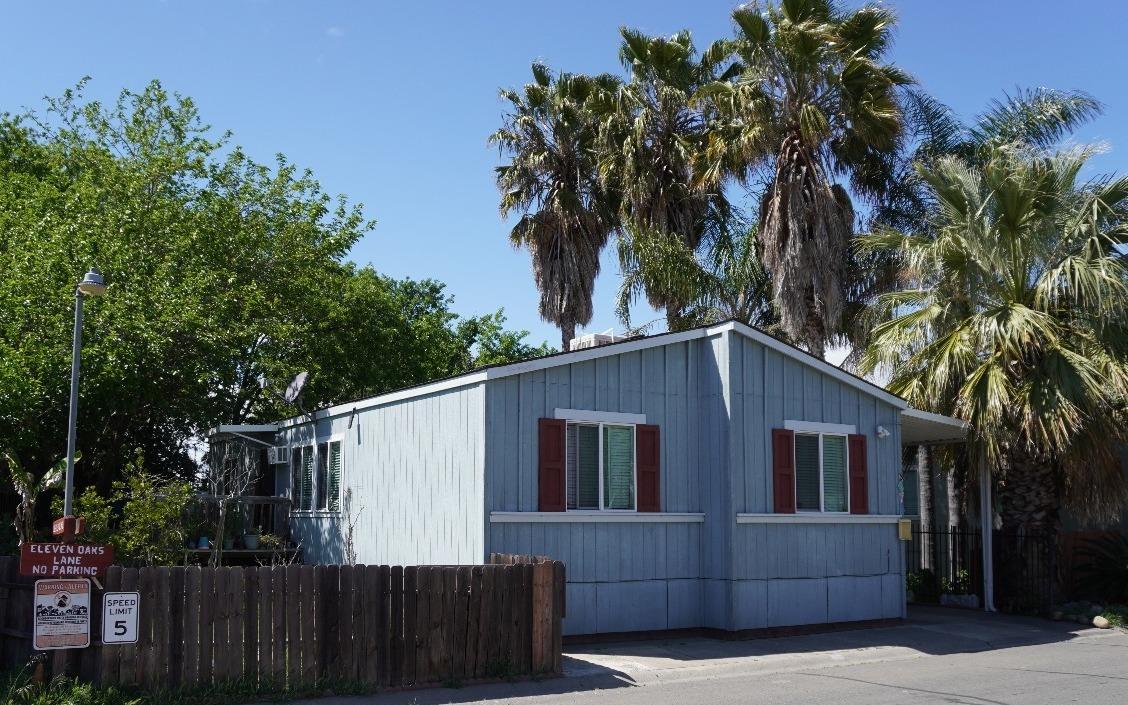 a front view of a house with a tree