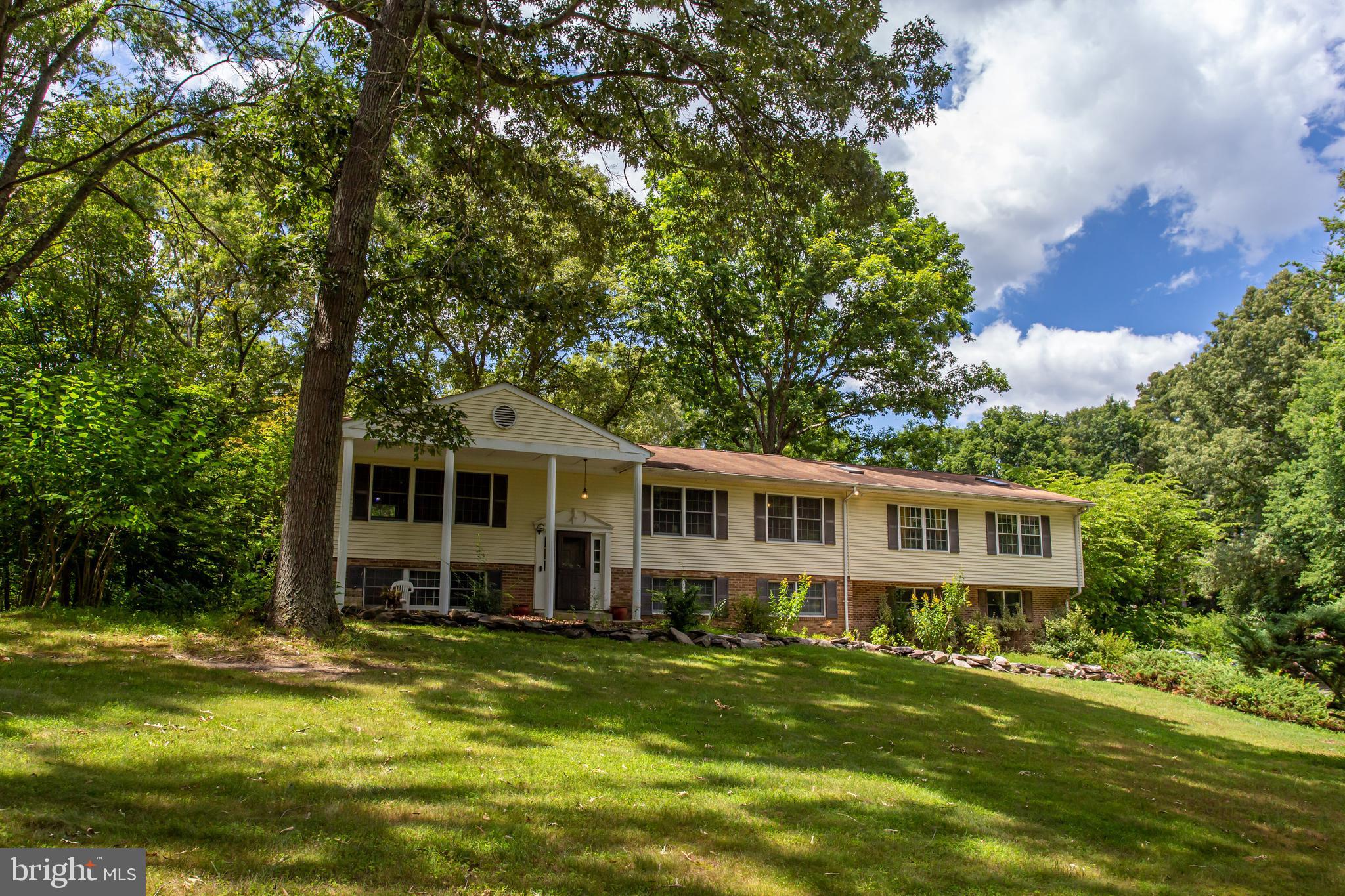 a view of a house with a backyard