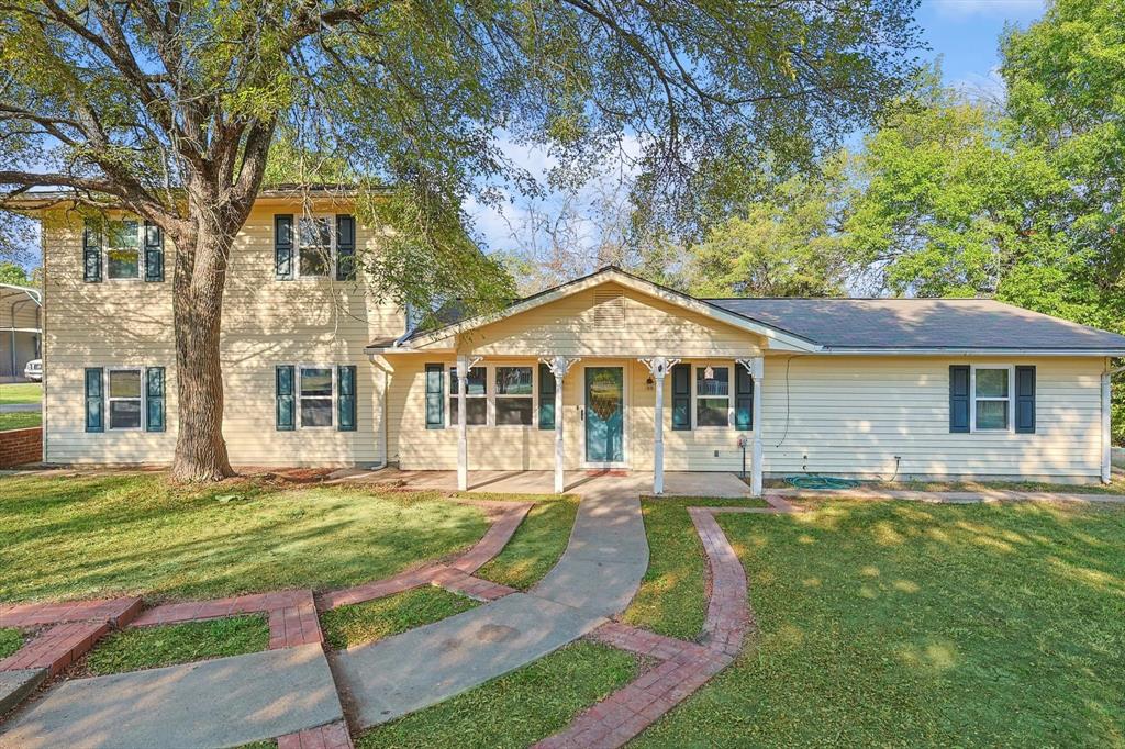 a front view of a house with a yard