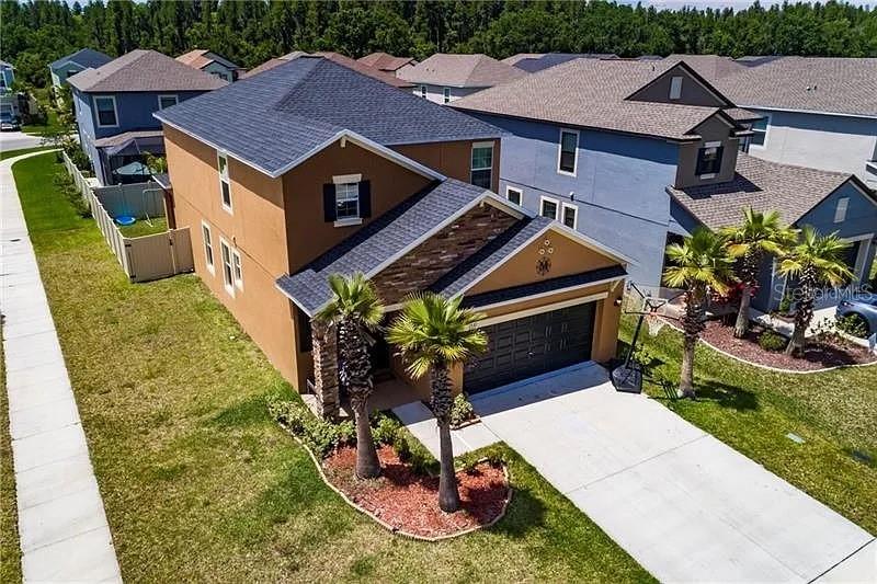 a aerial view of a house with a yard