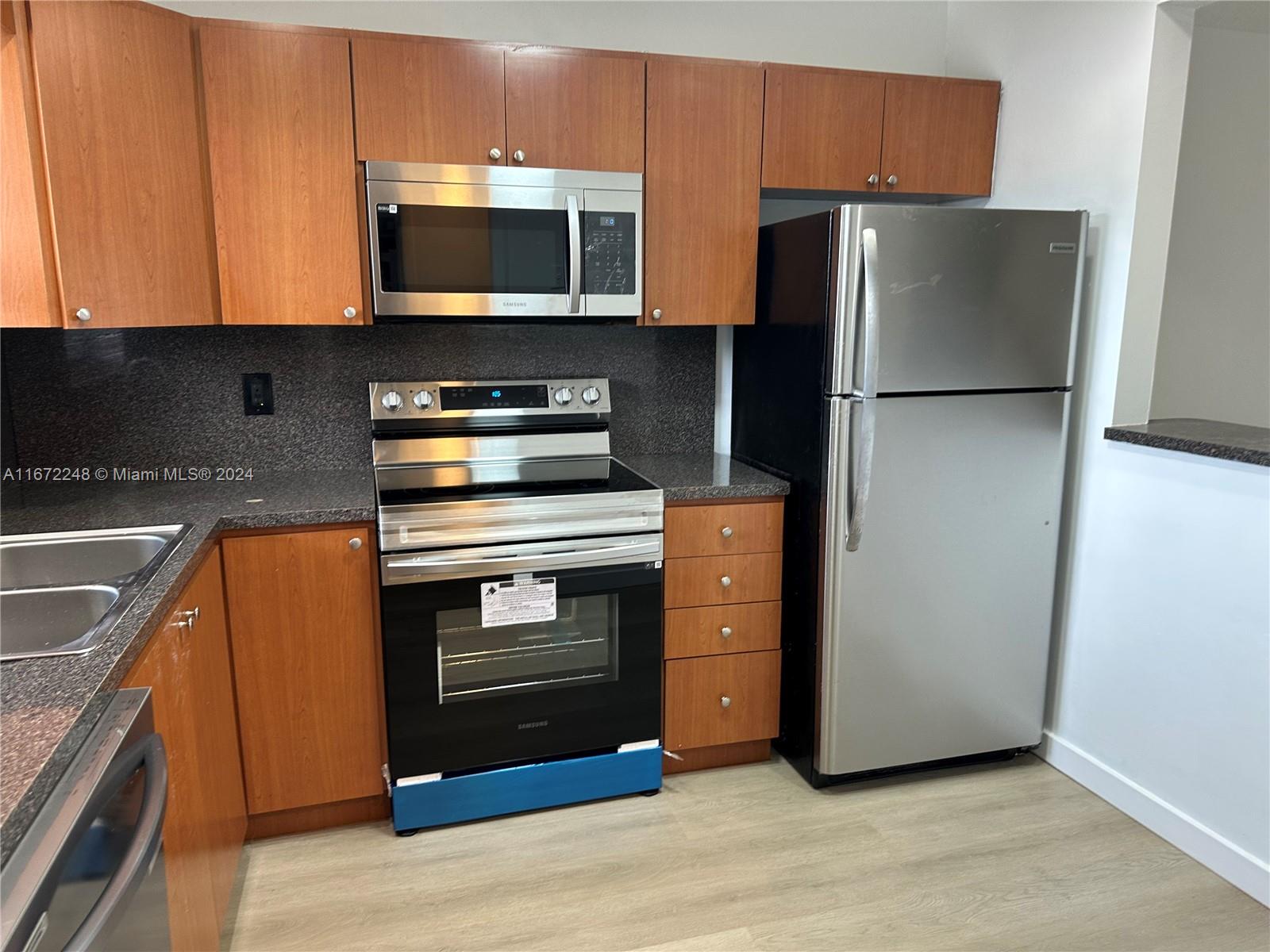 a kitchen with a refrigerator stove and microwave