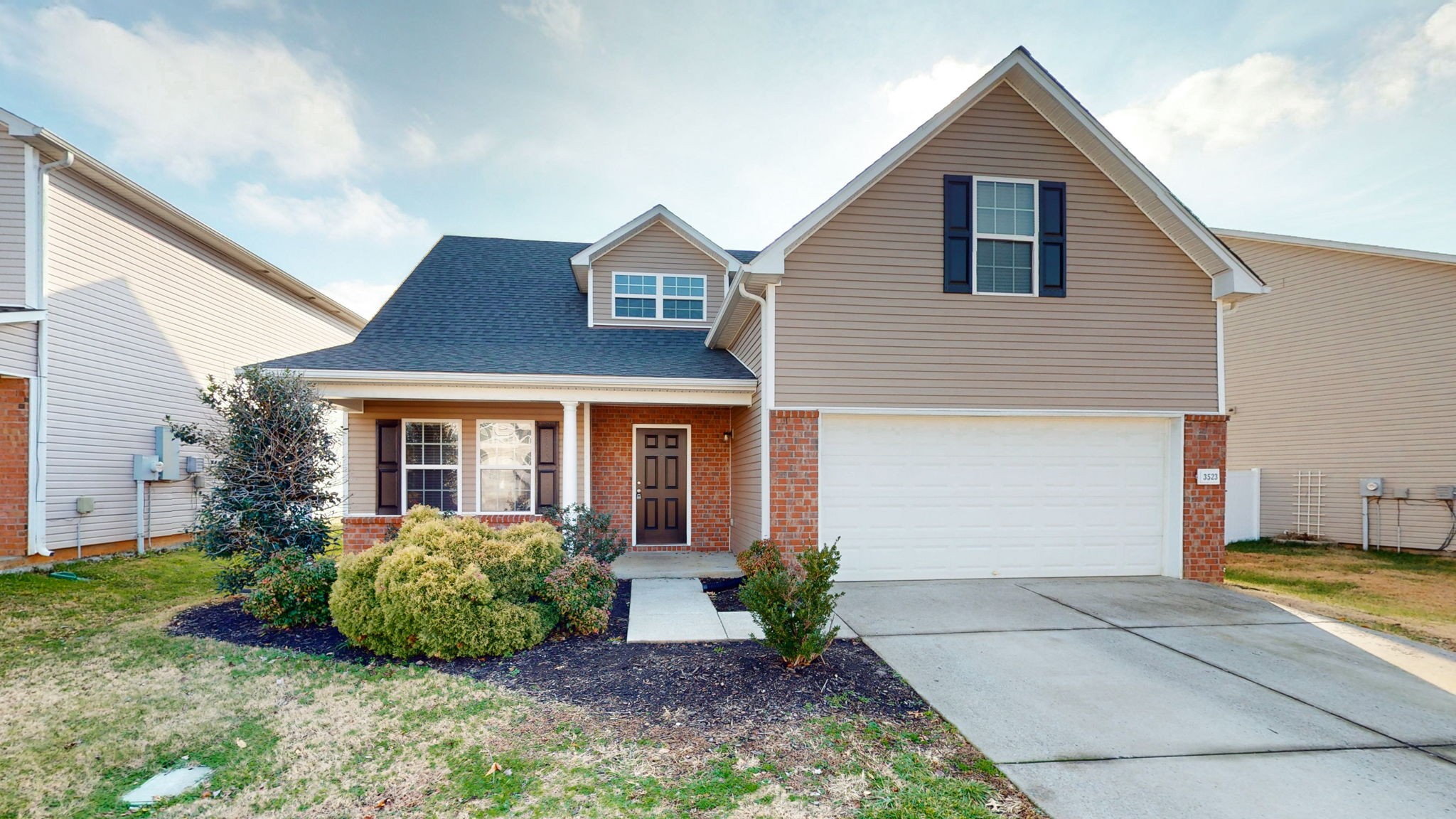 a front view of a house with a garden