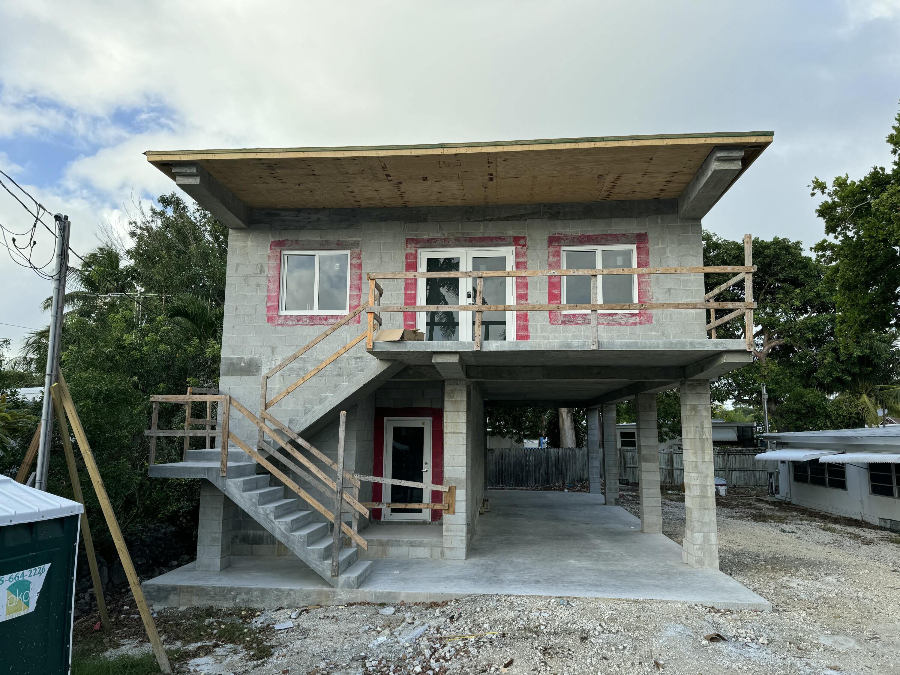 a view of a house with roof deck front of house