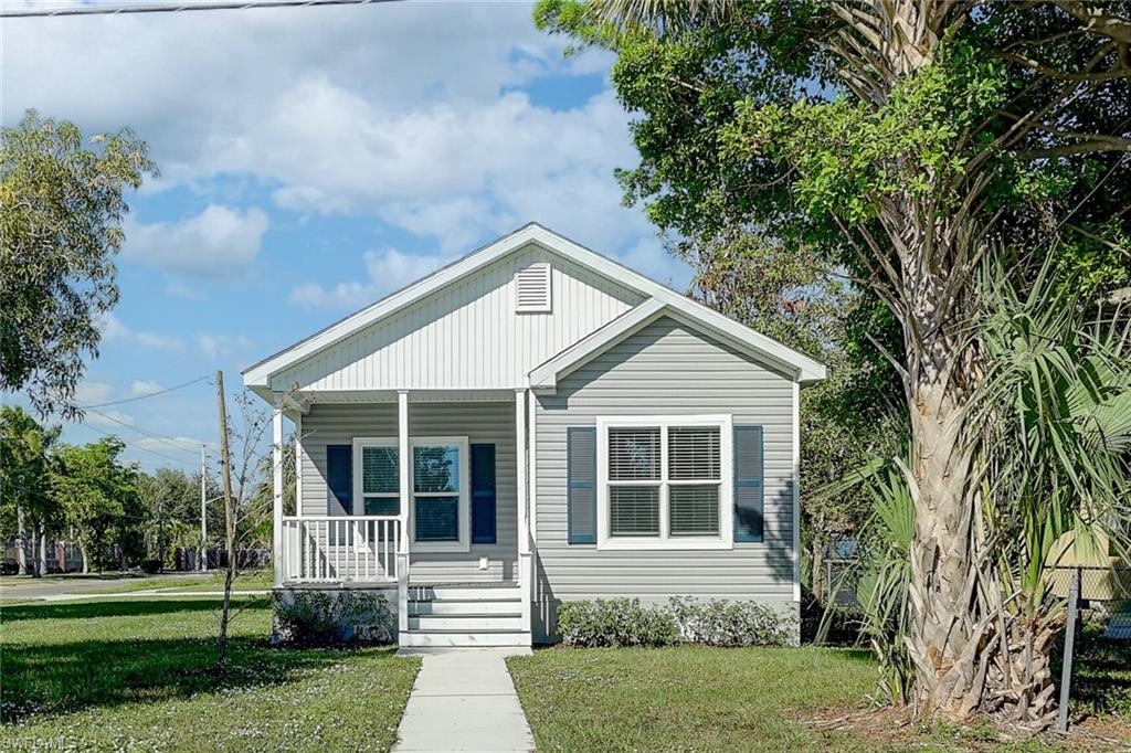 Bungalow-style house featuring covered porch and a front lawn