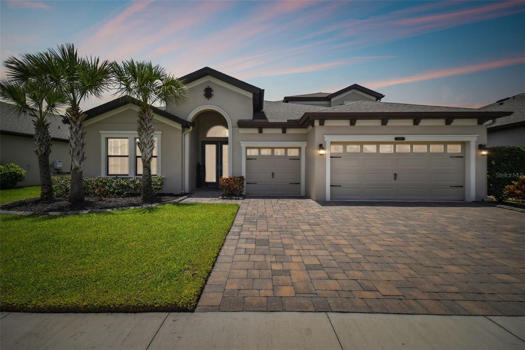 a front view of a house with a yard and garage