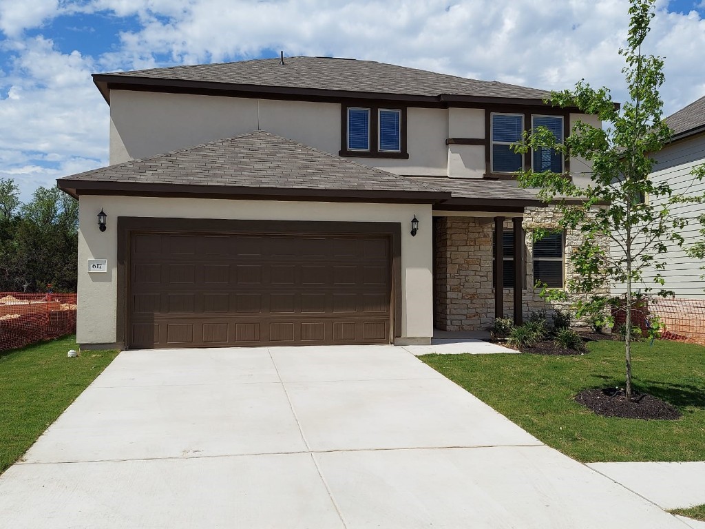 a front view of a house with yard