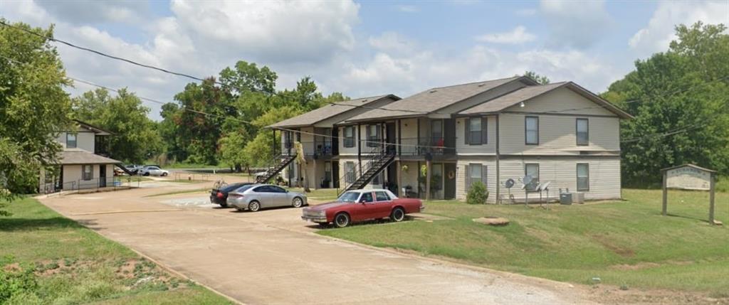 a car parked in front of house with a yard