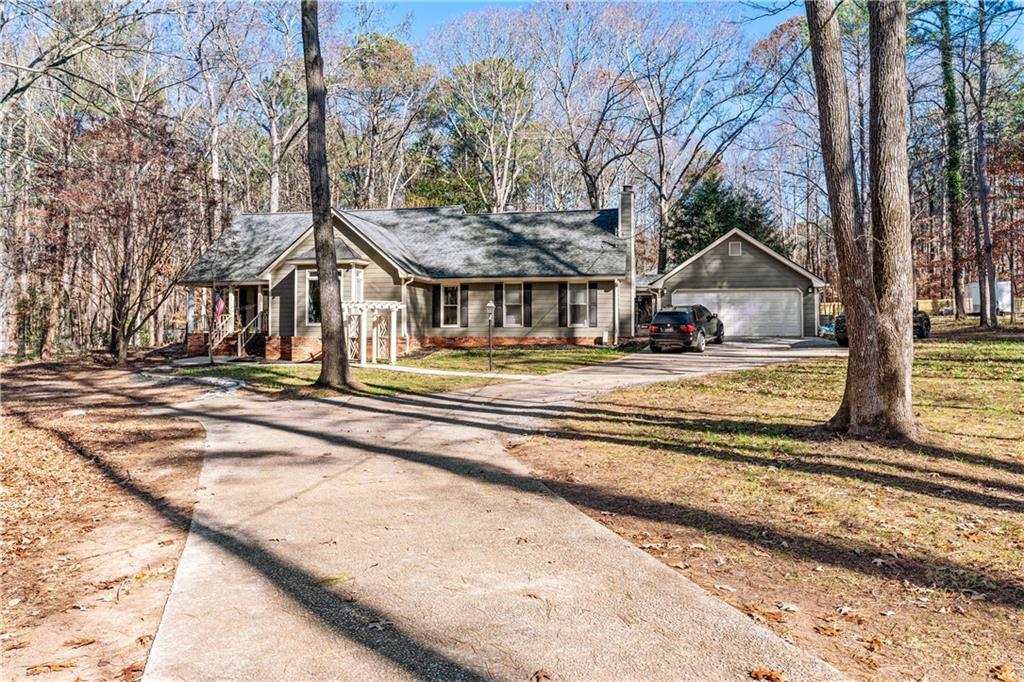 a view of a house with a large tree