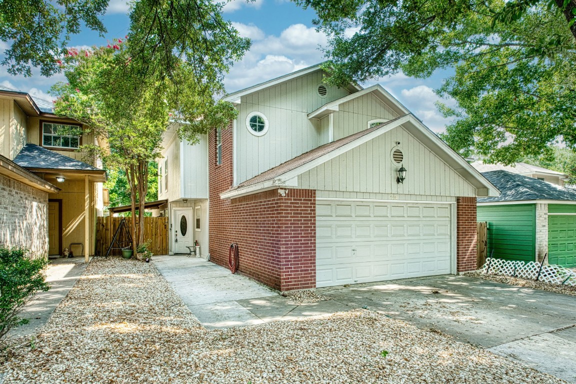 a view of a house with a garage and yard