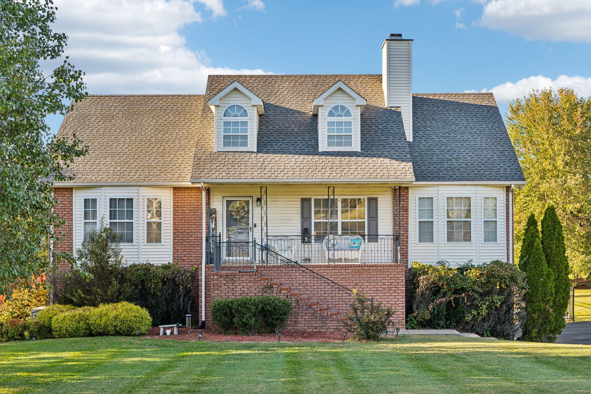 a front view of a house with a garden