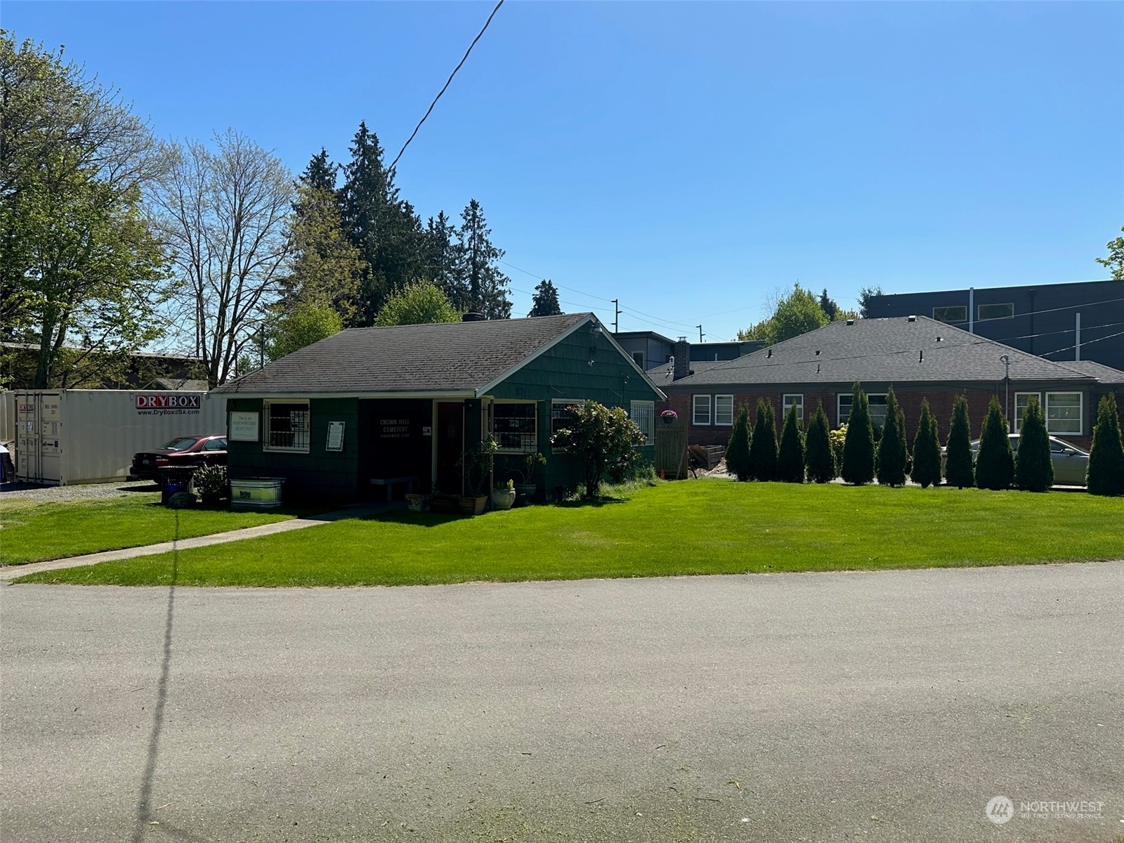 a front view of a house with a yard and trees