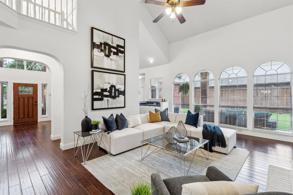 a living room with furniture fireplace and wooden floor