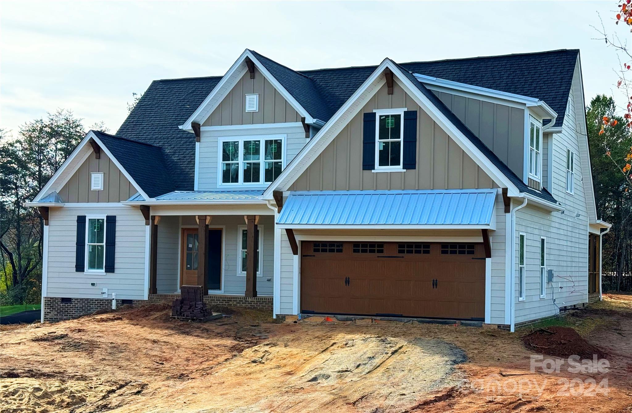 a view of a house with a yard and garage