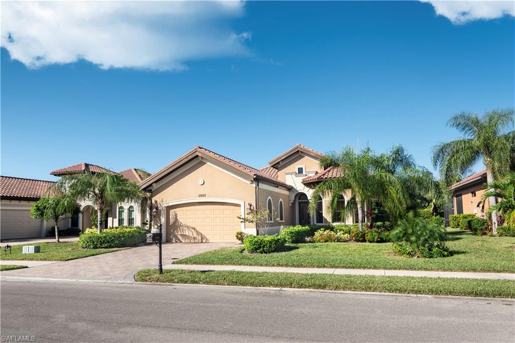 a front view of a house with a yard and garage