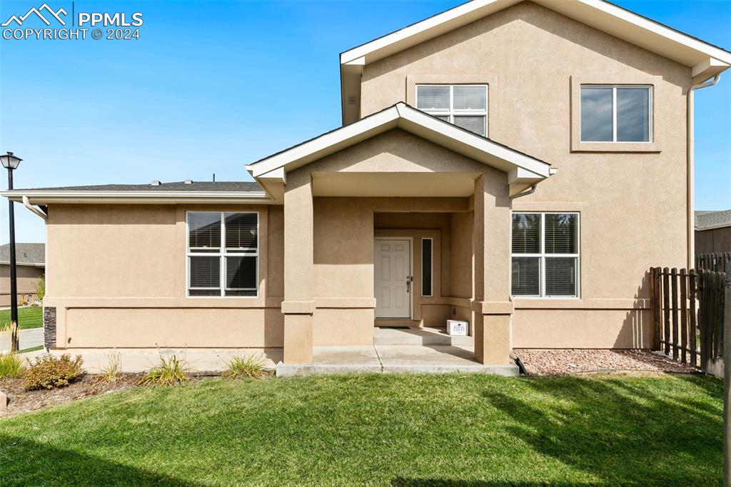 a front view of a house with a yard